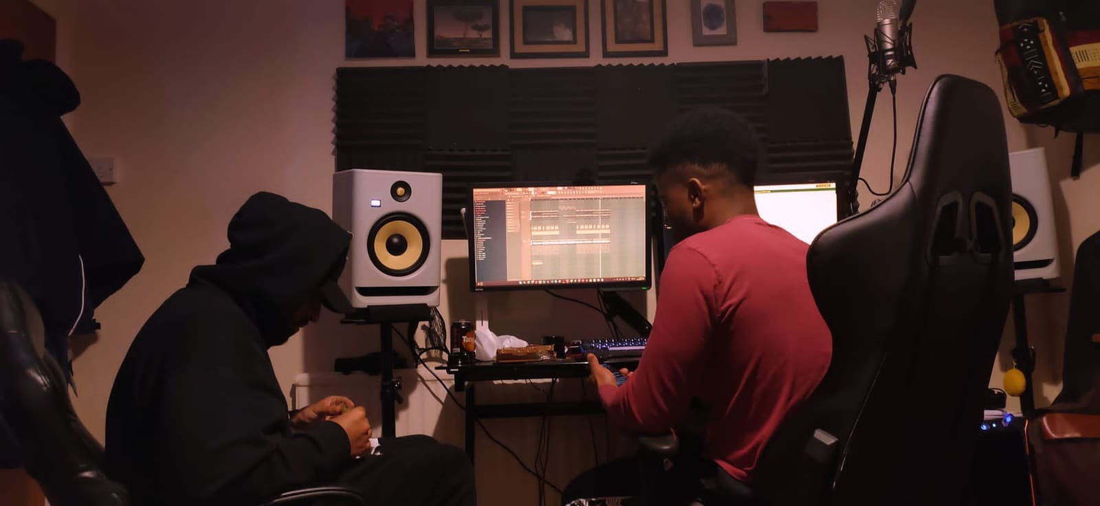 S3BA producing in the studio: a session open in FL Studio between the monitors, an artist listening in.